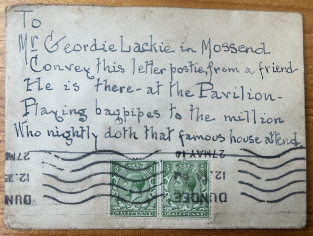Envelope addressed to Geordie Lackie in Mossend, covered with a handwritten verse directing the postman to deliver it to the performer at the Pavilion Theatre. Two green King George V halfpenny stamps are affixed near the bottom centre, crossed by Dundee postmark lines. The envelope is worn, creased, and slightly discoloured from age and use.