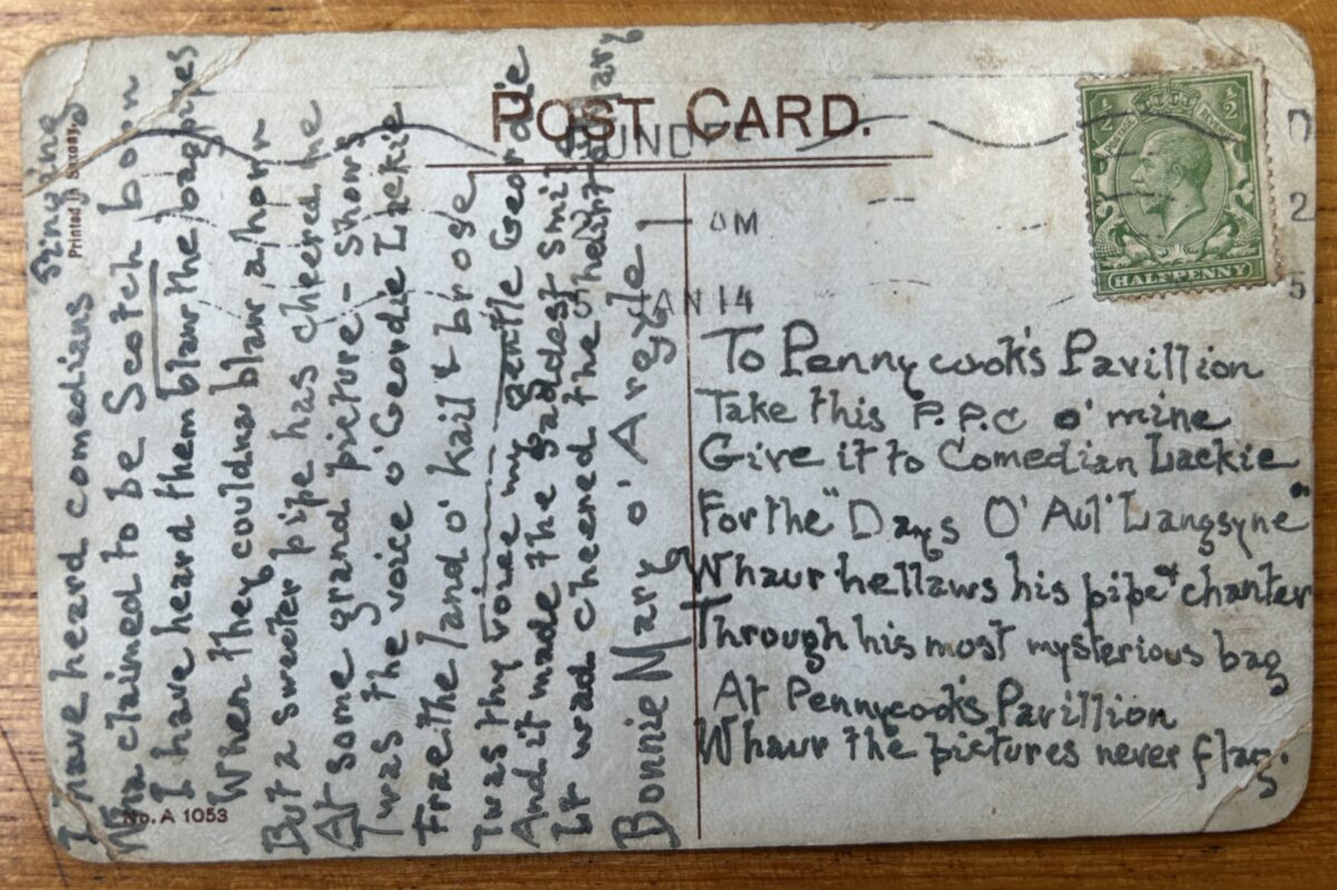 Reverse of a New Year postcard with a handwritten Scots verse addressed to Geordie Lackie at Pennycook’s Pavilion. The card includes a green King George V halfpenny stamp, postal markings, and a humorous message about music and entertainment.